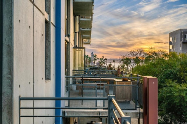 view of balcony at dusk