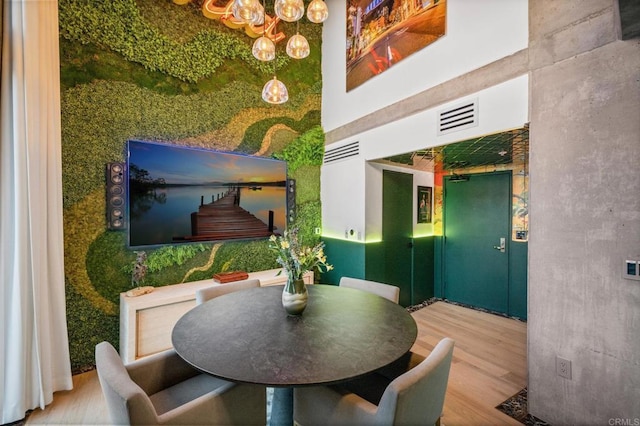 dining space featuring wood finished floors and visible vents