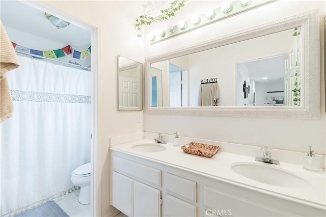 bathroom with double vanity, a shower with curtain, toilet, and a sink