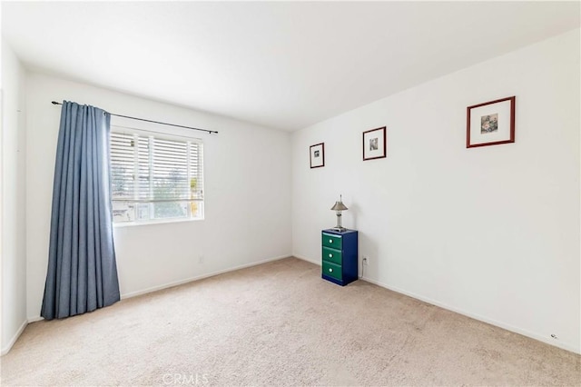 spare room with carpet floors and baseboards