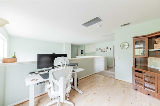 office area featuring visible vents, baseboards, and wood finished floors