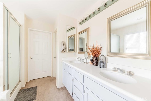 full bath featuring double vanity, a sink, and a shower stall