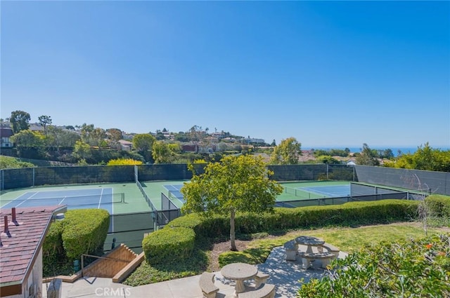 view of sport court featuring fence