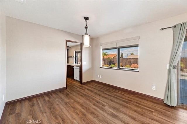 interior space featuring dark wood-style floors and baseboards