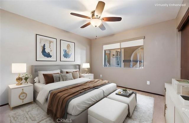 bedroom with a ceiling fan, light carpet, and baseboards