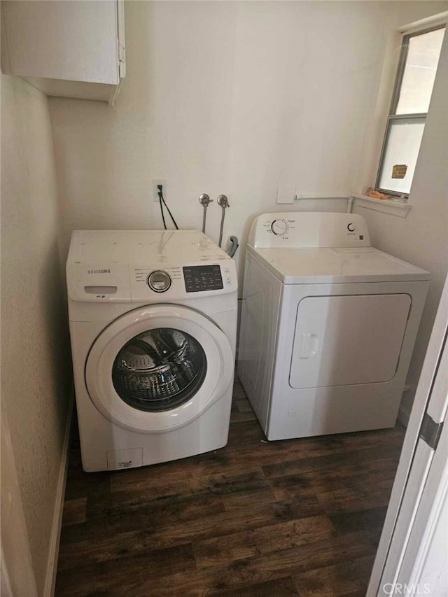 clothes washing area featuring laundry area, dark wood finished floors, and independent washer and dryer