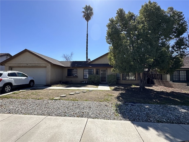 view of front of property with a garage, driveway, and stucco siding