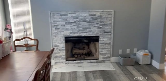 26734 Caravan Cir, Corona, CA 92883 - detailed view of a fireplace with flush hearth, wood finished floors, and baseboards