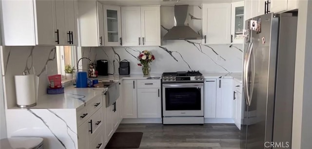 26734 Caravan Cir, Corona, CA 92883 - kitchen featuring stainless steel appliances, wall chimney range hood, light stone counters, wood finished floors, and white cabinetry