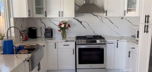 26734 Caravan Cir, Corona, CA 92883 - kitchen with stainless steel range with gas cooktop, range hood, and white cabinets