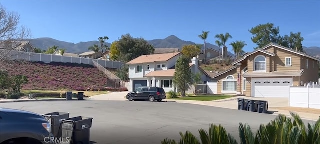 26734 Caravan Cir, Corona, CA 92883 - view of asphalt road with a mountain view, a residential view, sidewalks, and curbs