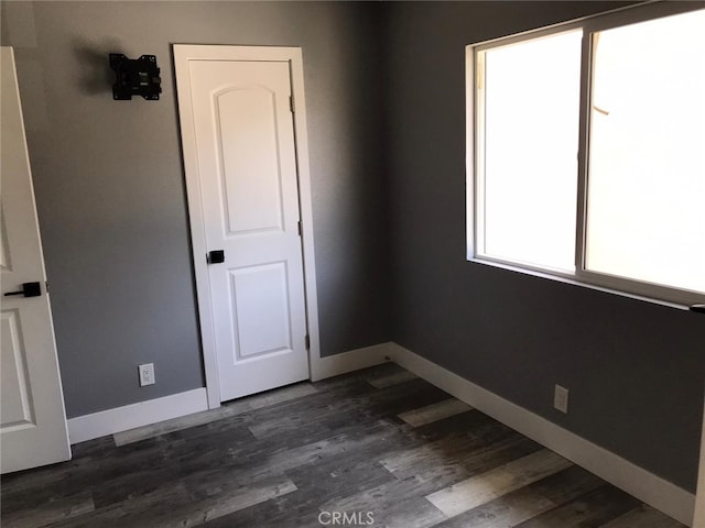 26734 Caravan Cir, Corona, CA 92883 - empty room featuring baseboards and dark wood-style flooring