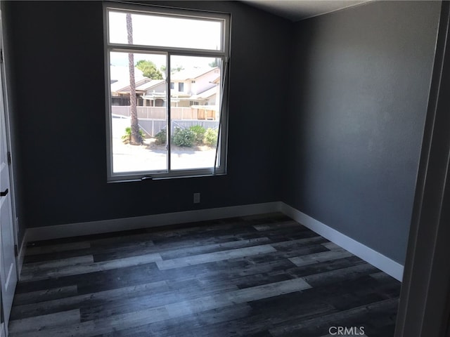 26734 Caravan Cir, Corona, CA 92883 - empty room with baseboards and dark wood-type flooring