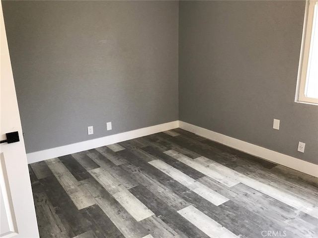 26734 Caravan Cir, Corona, CA 92883 - spare room featuring dark wood-style floors and baseboards