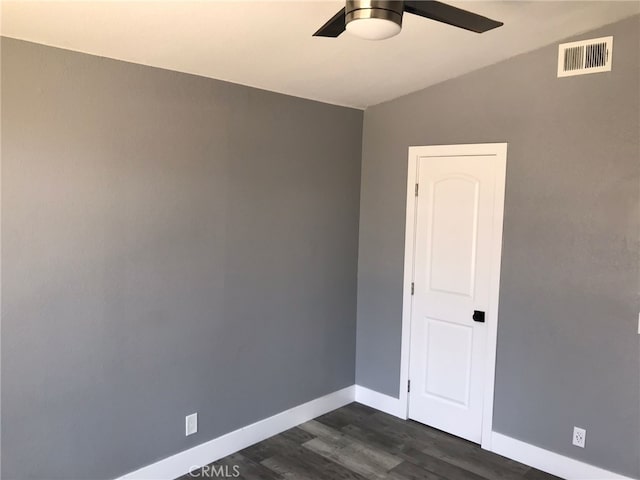 26734 Caravan Cir, Corona, CA 92883 - empty room with a ceiling fan, dark wood-style flooring, and baseboards