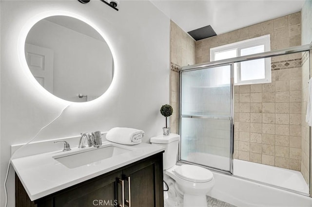 bathroom featuring vanity, toilet, and enclosed tub / shower combo