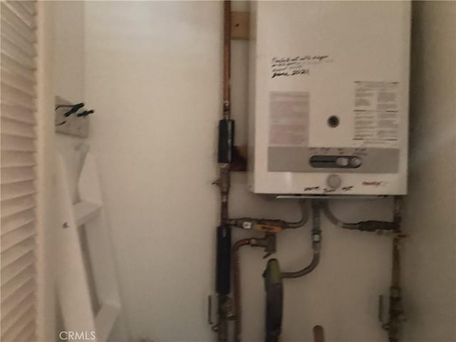 utility room with water heater