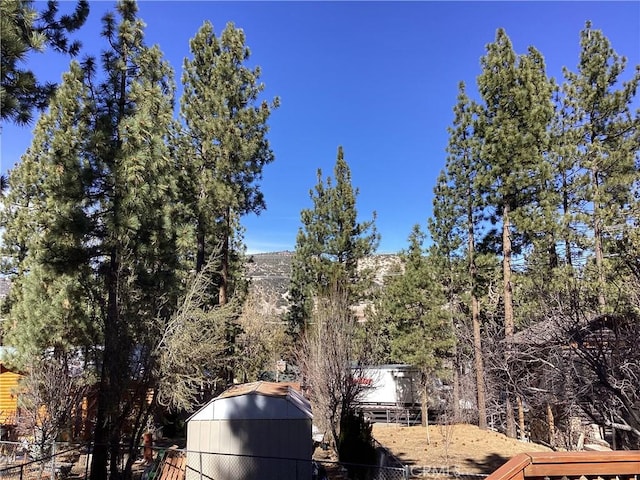 view of home's exterior featuring a storage shed, an outdoor structure, and fence