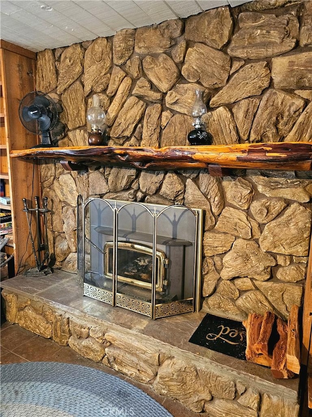 interior details featuring a paneled ceiling and a fireplace