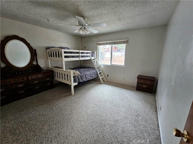 bedroom featuring a ceiling fan, a textured ceiling, and carpet flooring