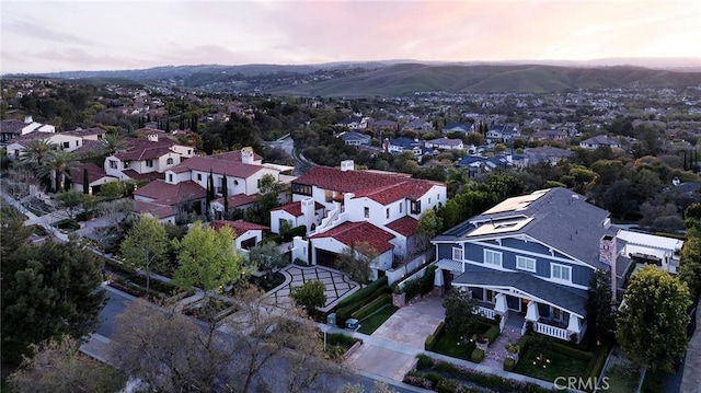 drone / aerial view featuring a residential view and a mountain view