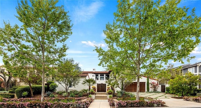 view of front of house with driveway and stucco siding