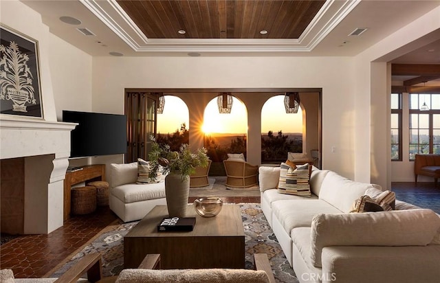 living room with a fireplace, a raised ceiling, wood ceiling, and visible vents