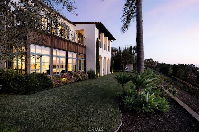 exterior space with a yard and stucco siding