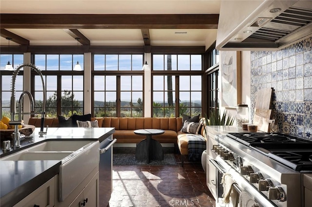 sunroom featuring a sink and beamed ceiling