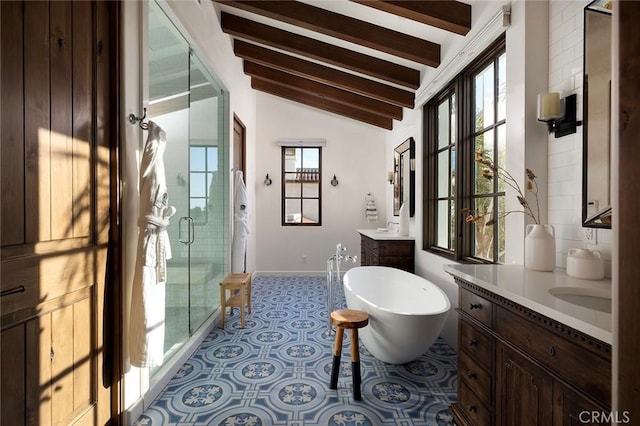 full bathroom with a soaking tub, lofted ceiling with beams, two vanities, a shower stall, and tile patterned floors