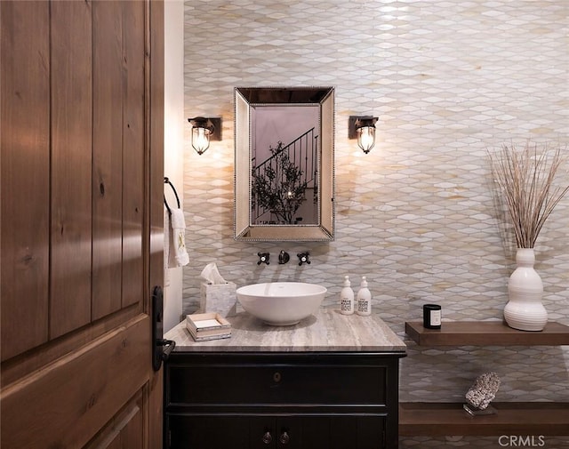 bathroom featuring tasteful backsplash and vanity