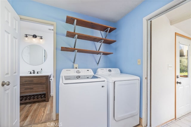 43317 Running Deer Ct, Coarsegold, CA 93614 - laundry area with washer and clothes dryer and light wood-type flooring