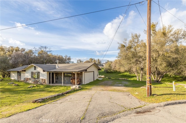43317 Running Deer Ct, Coarsegold, CA 93614 - view of front of house featuring driveway, a garage, a front lawn, stone siding, and a chimney