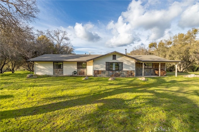 view of front of house with stone siding and a front lawn