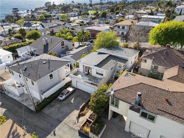 drone / aerial view featuring a residential view and a water view