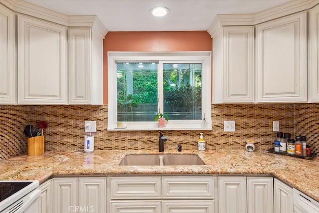 kitchen with a sink, tasteful backsplash, white cabinetry, light stone countertops, and white range with electric stovetop