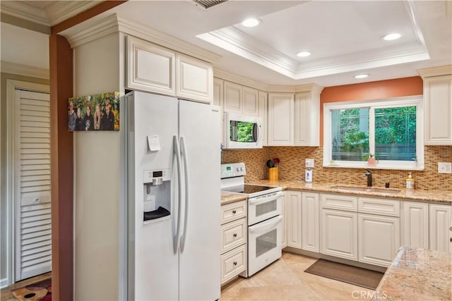 kitchen featuring a sink, ornamental molding, white appliances, and backsplash