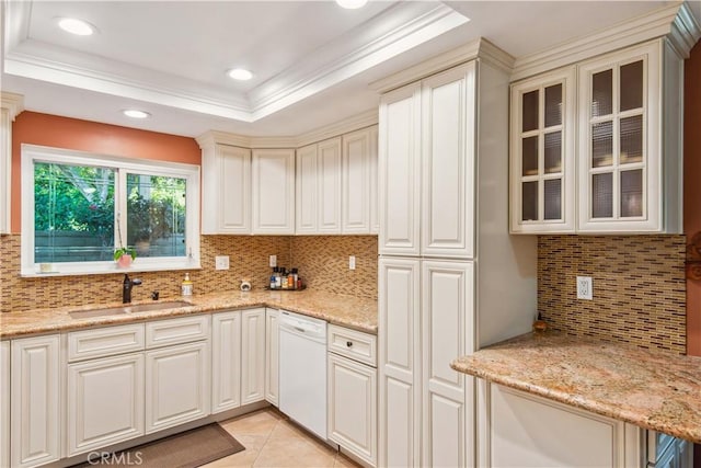 kitchen featuring a sink, backsplash, light stone counters, and dishwasher