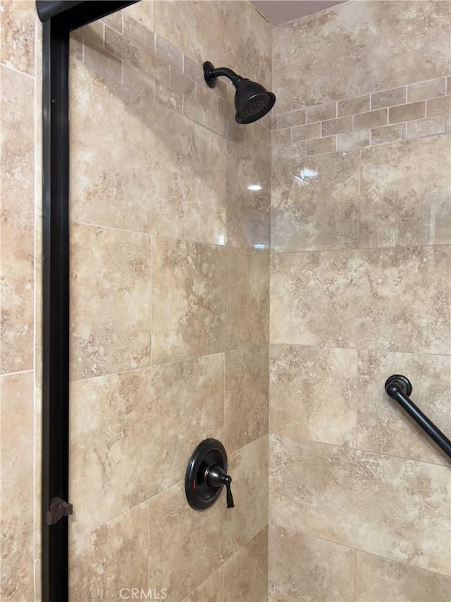 interior details with a tile shower