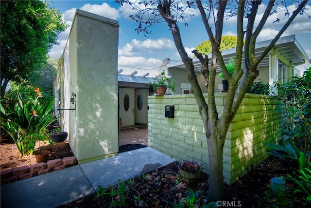 view of side of property featuring fence and a chimney