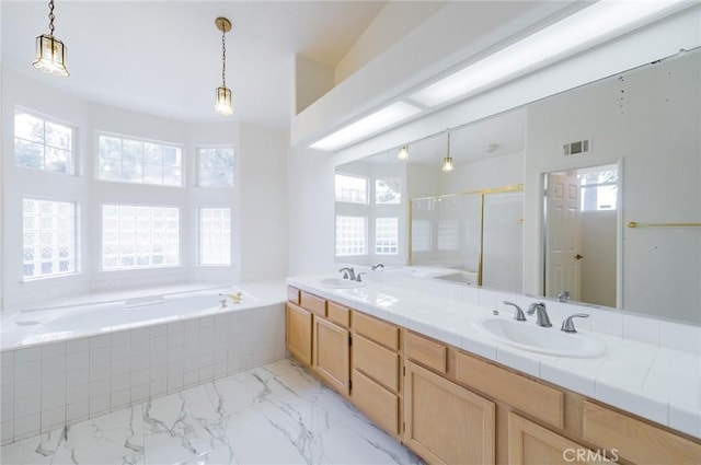 bathroom with a garden tub, visible vents, a sink, and a stall shower