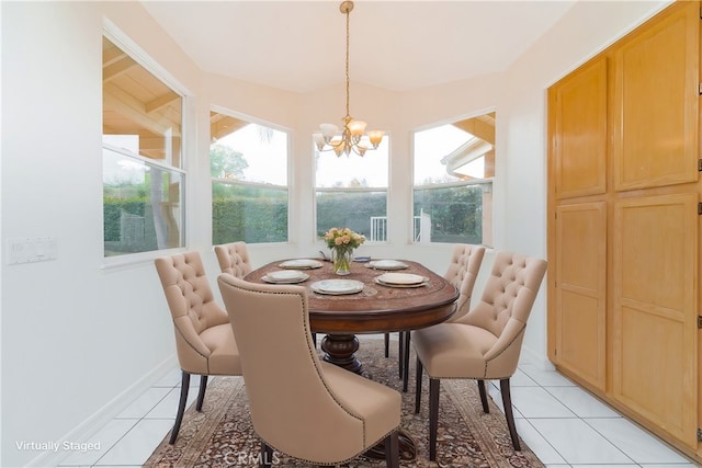 dining room featuring light tile patterned floors, a healthy amount of sunlight, baseboards, and an inviting chandelier