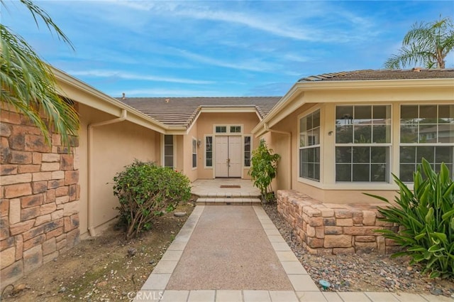 view of exterior entry featuring stucco siding