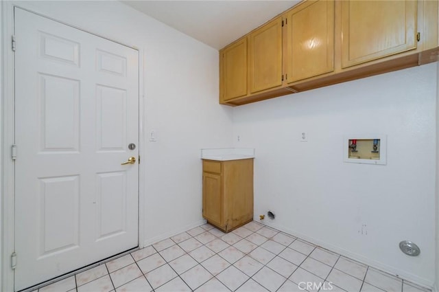 washroom with cabinet space, hookup for a washing machine, baseboards, and light tile patterned floors