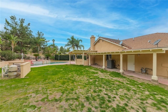 view of yard with a fenced in pool, cooling unit, a patio area, and fence