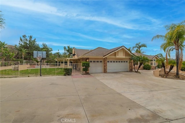 view of front of house featuring a garage, driveway, a gate, and fence