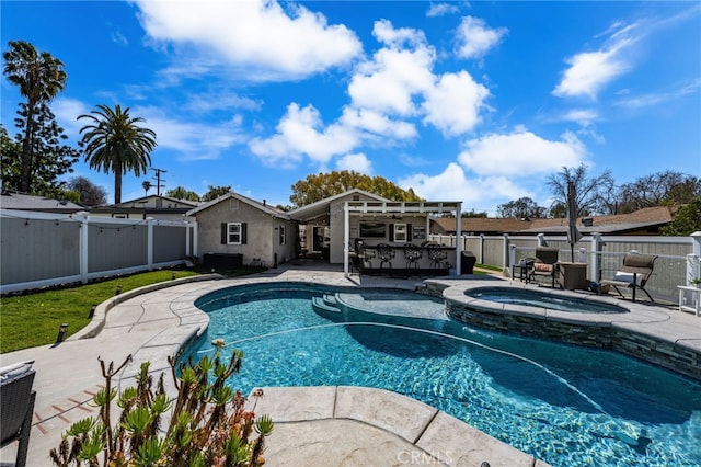 view of swimming pool featuring a patio, a fenced backyard, a pool with connected hot tub, and outdoor dry bar