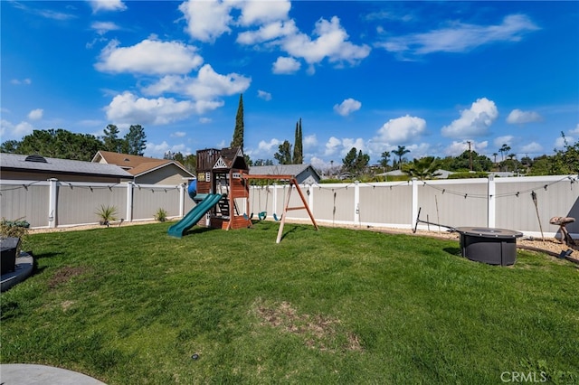 view of yard with a fenced backyard and a playground