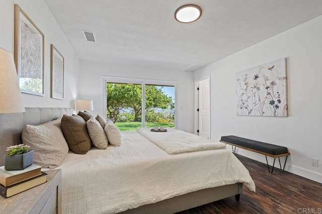 bedroom featuring access to exterior, visible vents, baseboards, and dark wood-style flooring