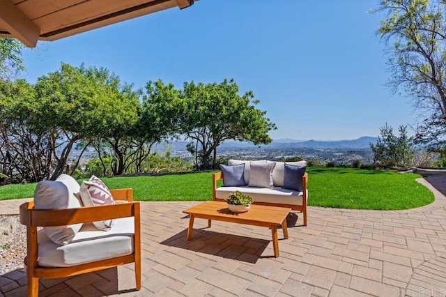 view of patio / terrace featuring an outdoor living space and a mountain view